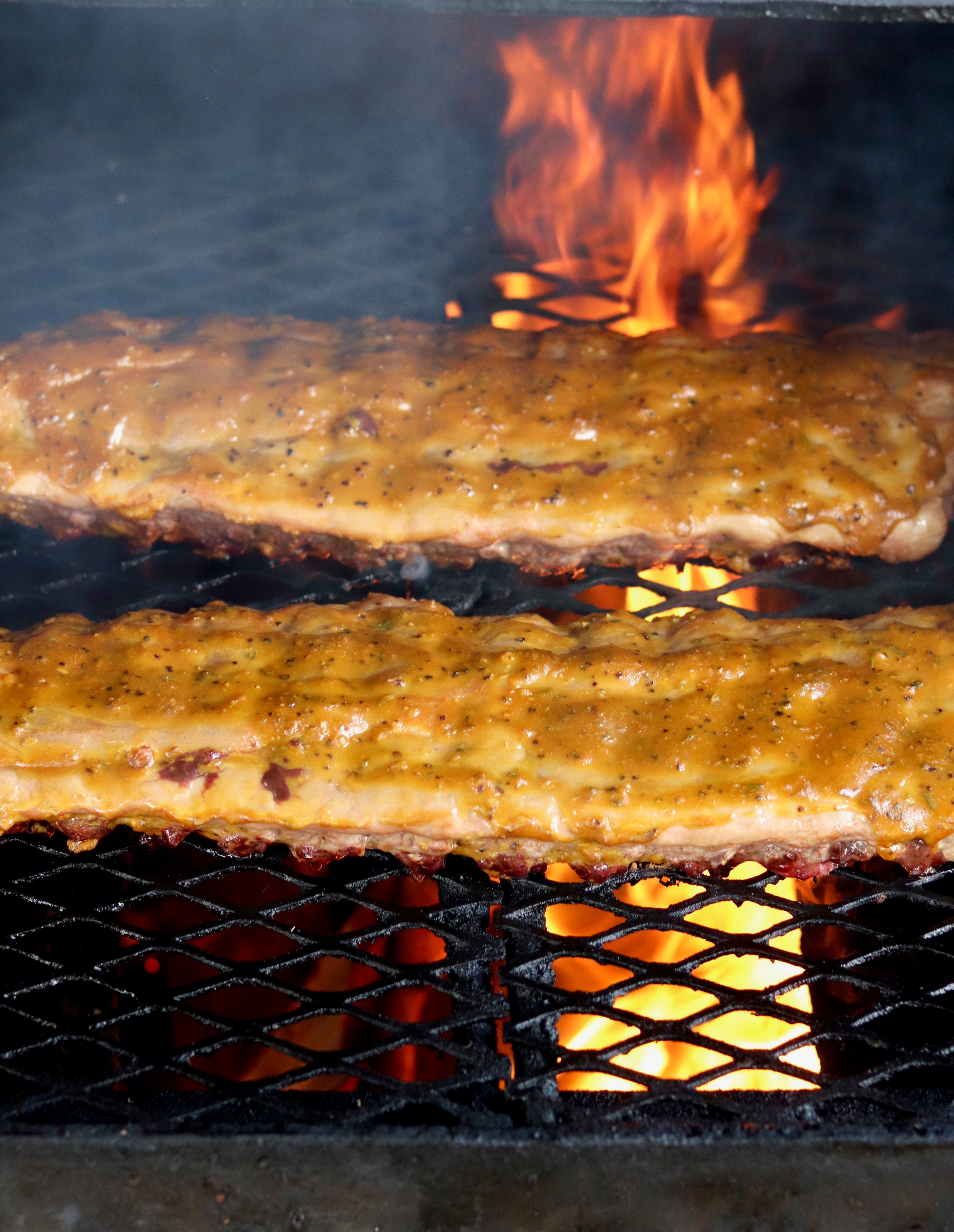 Baby Back Ribs on grill with fire in background