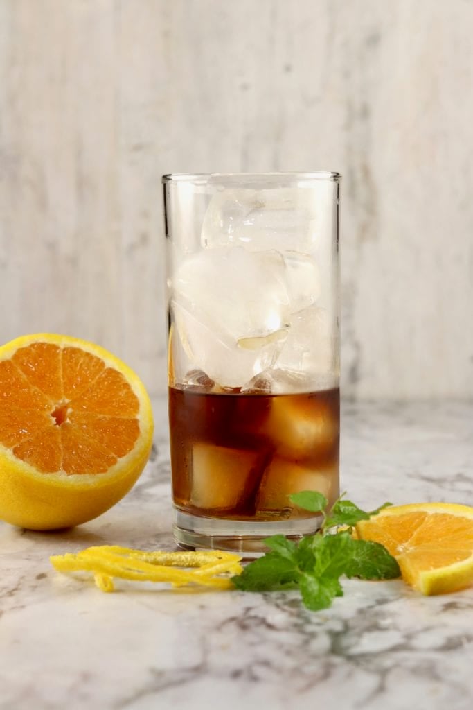 Glass of ice filled half full with black spiced rum