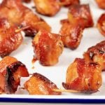 Bacon wrapped water chestnuts on a white pan