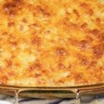 Cheesy Funeral Potatoes casserole in glass baking dish