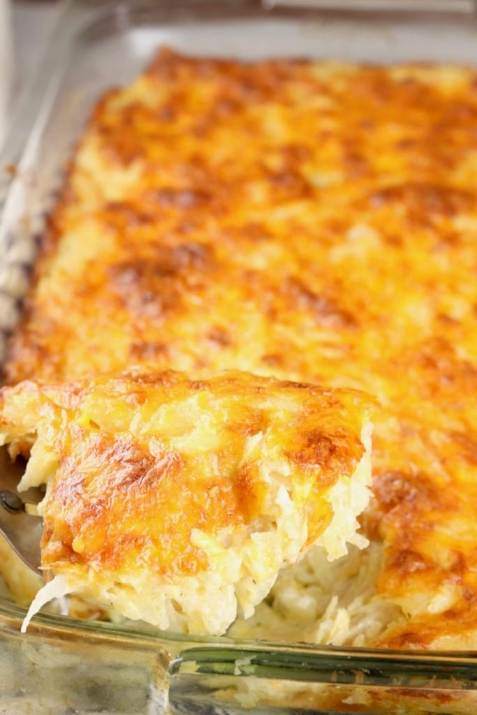 Scoop of hashbrown casserole over dish