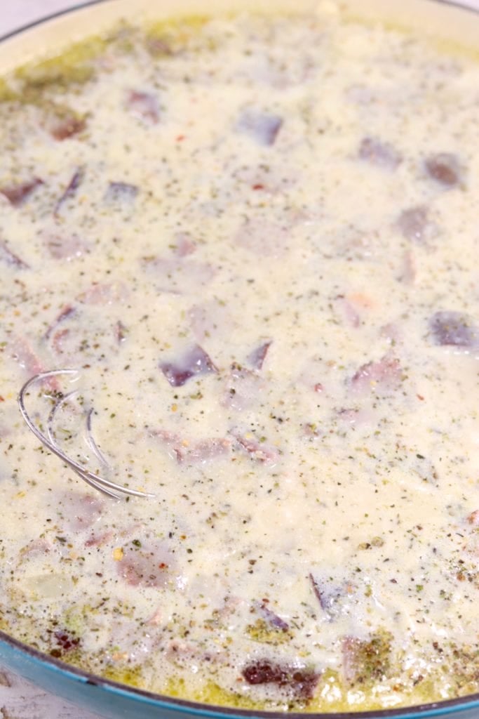 adding milk to potato sausage soup