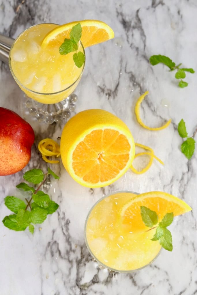 Overhead view of orange juice cocktail with mint garnish