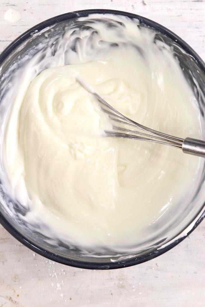 Powdered Sugar Icing in a bowl with whisk