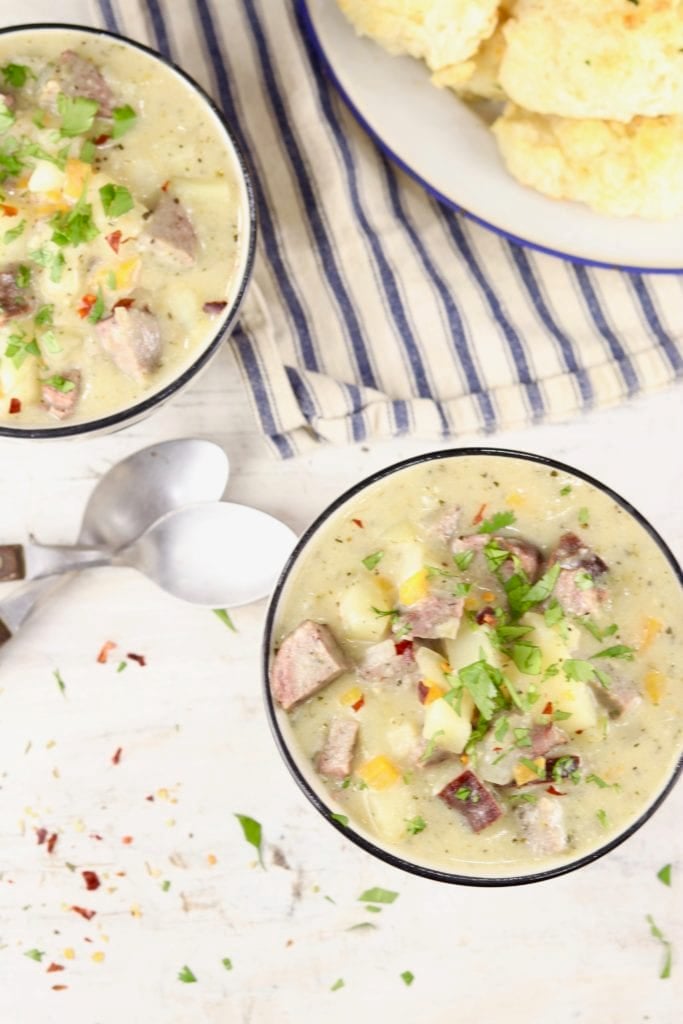 2 bowls of potato soup and a plate of biscuits