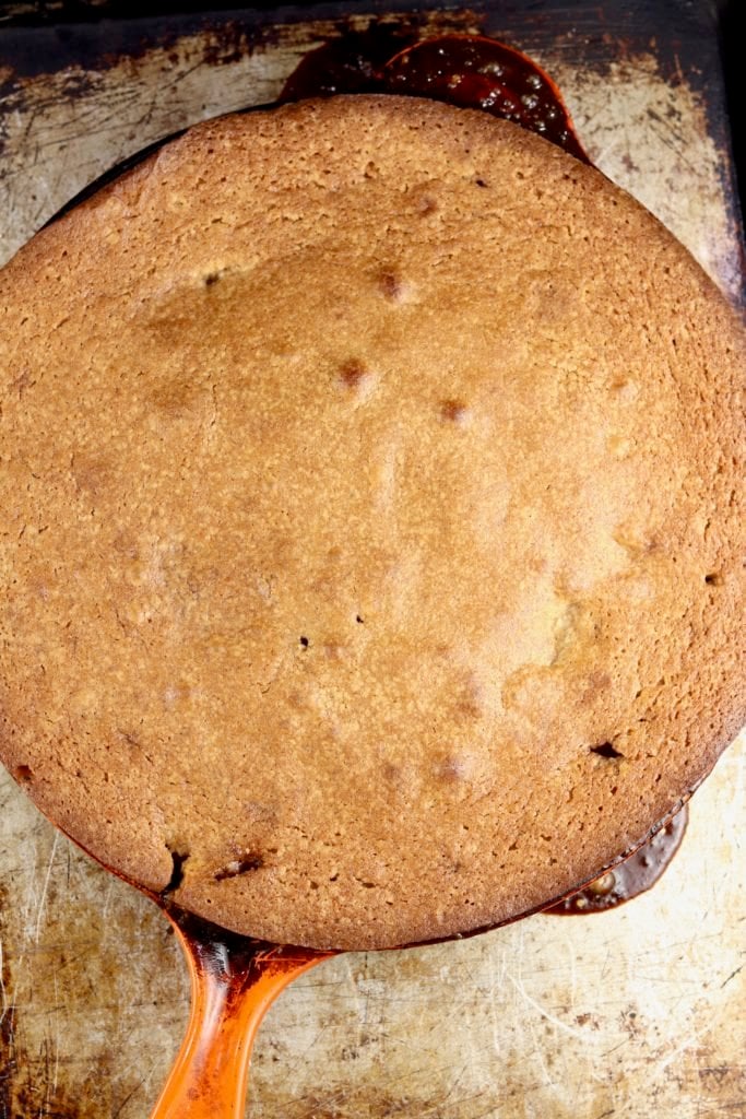 Baked apple spice cake with walnuts in a skillet