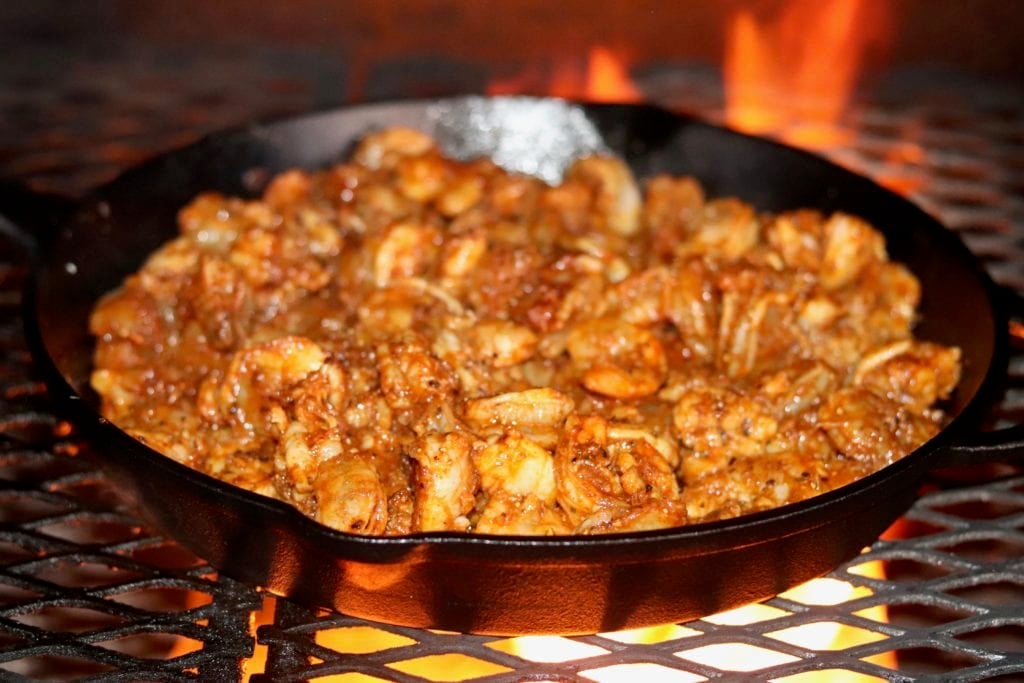 Skillet of blackened shrimp on grill