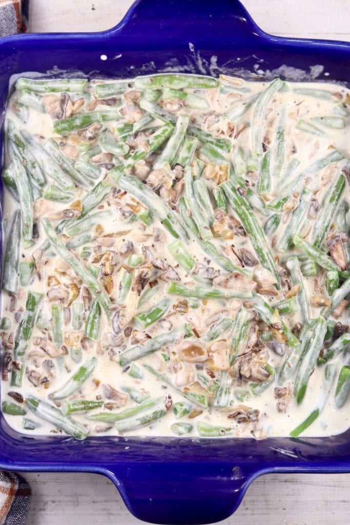 Creamy green bean casserole in a blue baking dish