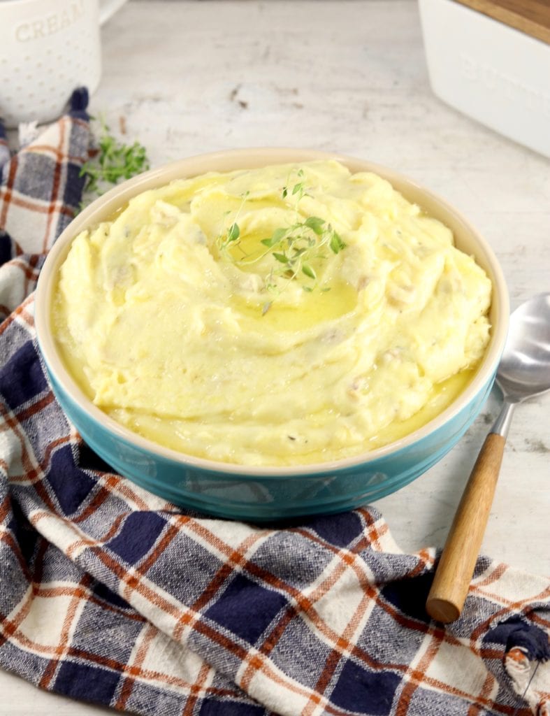 Bowl of creamy mashed potatoes with a plaid napkin