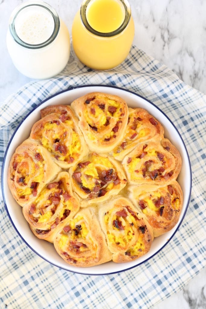Ham and egg rolls with orange juice and milk bottles