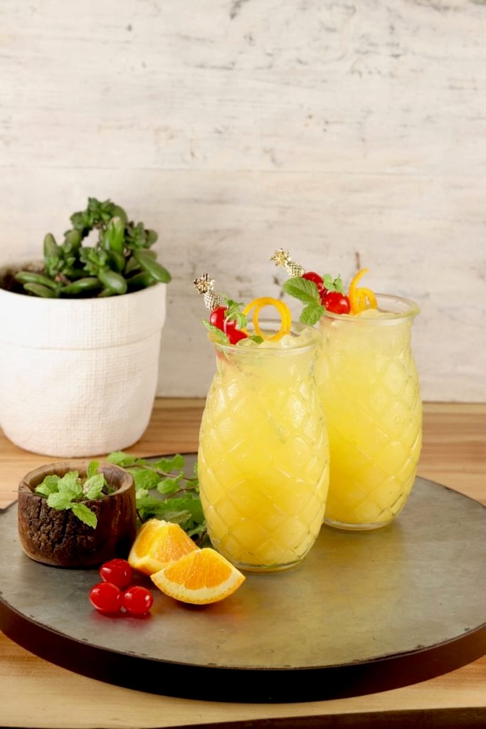 Tray with 2 vodka cocktails in pineapple shaped glasses