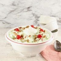 Bowl of pistachio fluff dessert with cherries