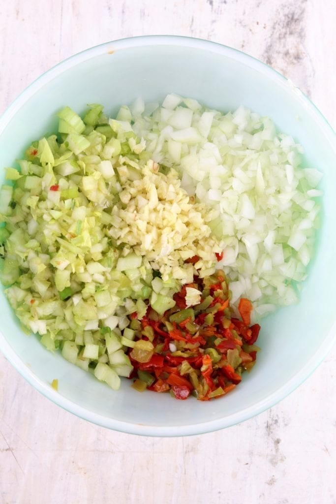 Holy Trinity of onions, bell peppers and celery plus minced garlic
