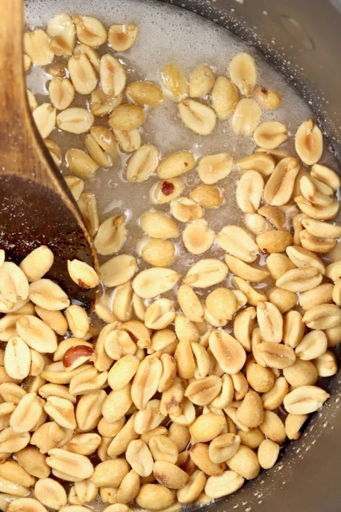 Peanuts stirred into brittle mixture