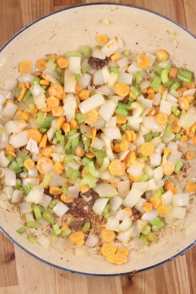 dutch oven with cooked carrots, celery and onions