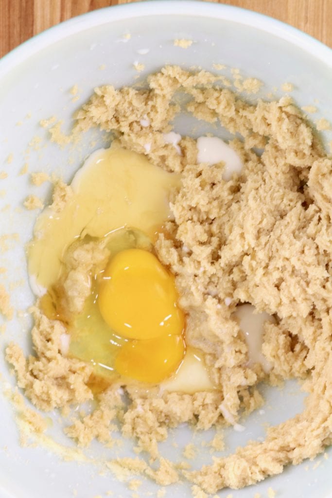 Making peanut butter cookie dough with egg and vanilla