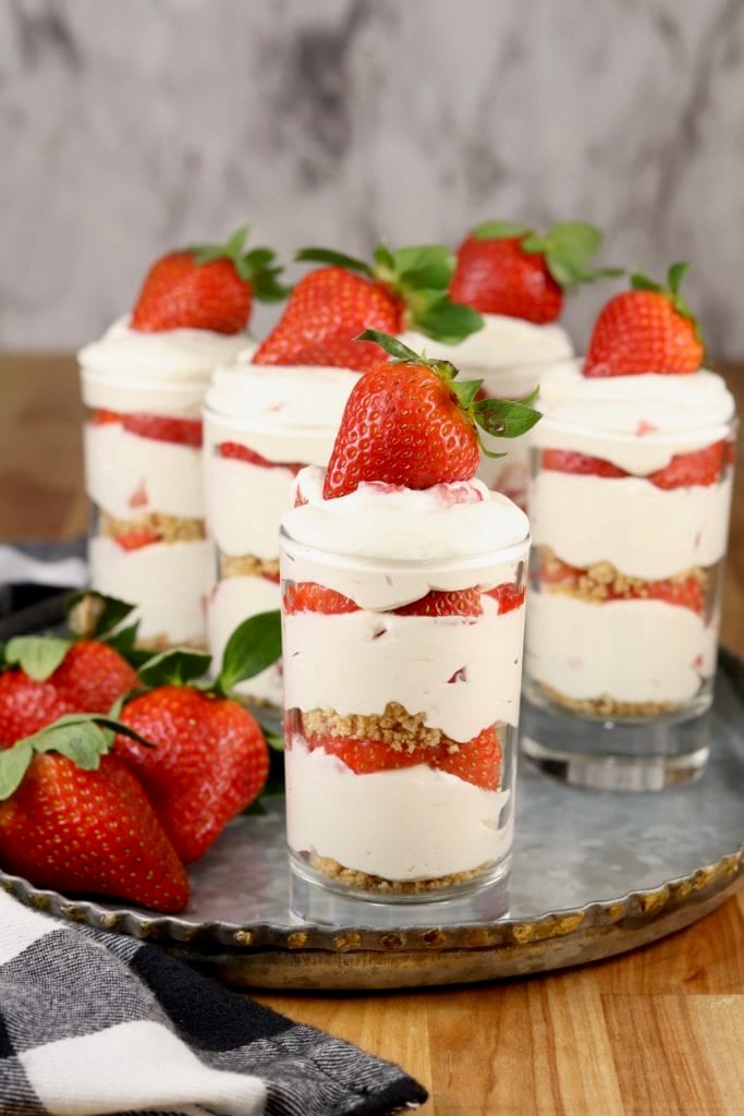 No Bake Strawberry Cheesecakes are a delicious treat for any occasion. Only 6 ingredients and about 10 minutes to make this easy dessert! Strawberry cheesecake layer dessert in juice glasses