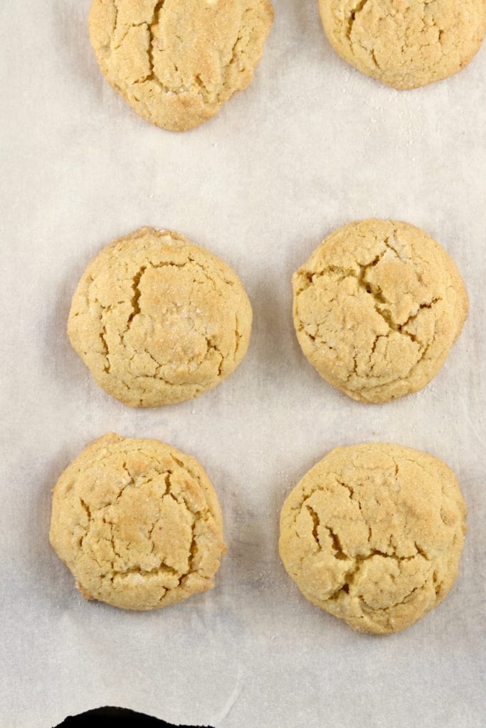 Baked peanut butter cookies on a lined baking sheet