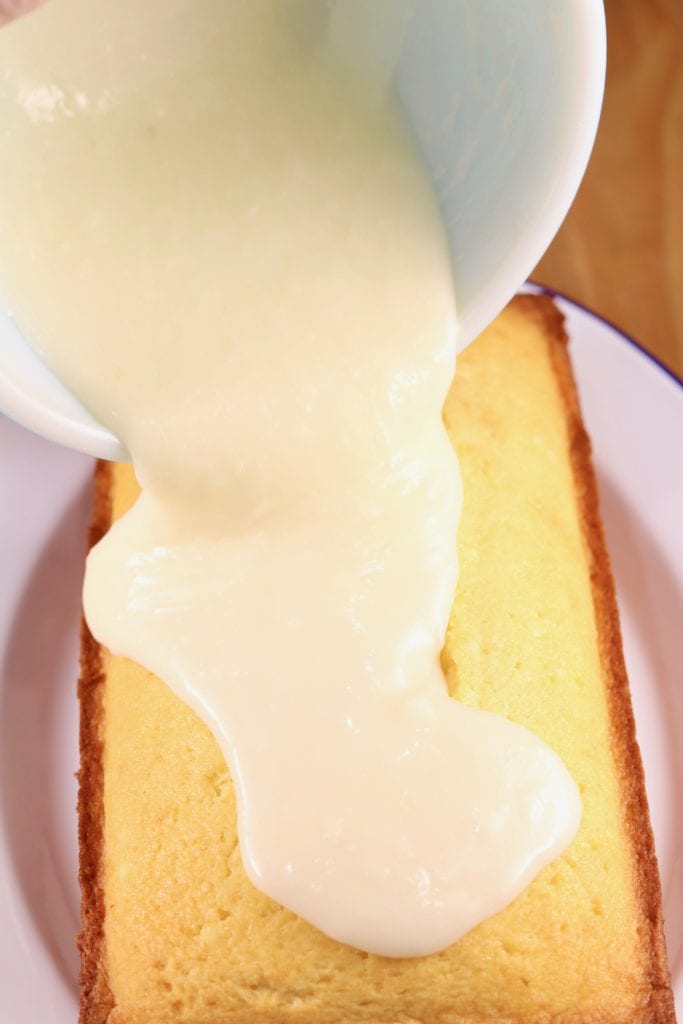 pouring buttermilk glaze over pound cake