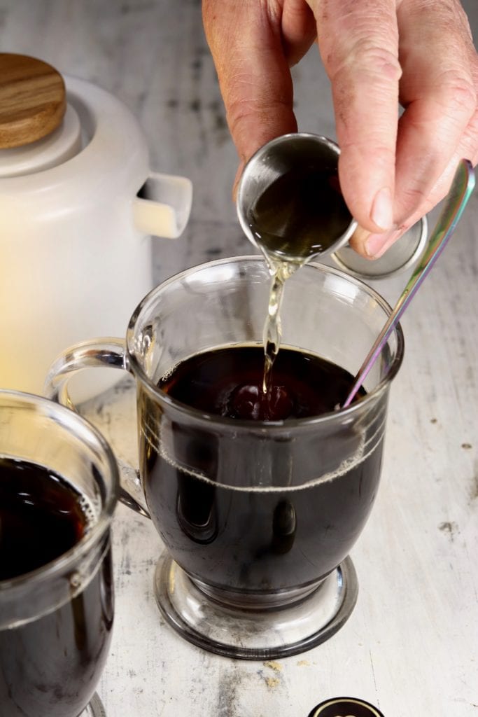 adding a shot of Irish Whiskey to coffee