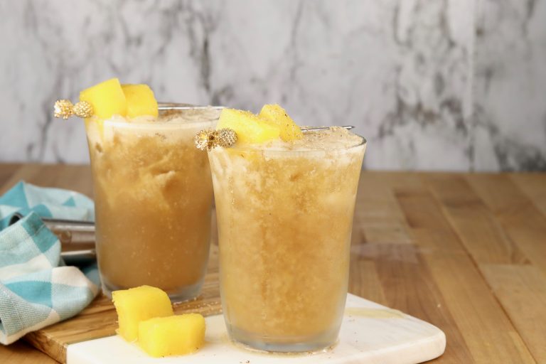 2 Painkiller cocktails with pineapple garnish