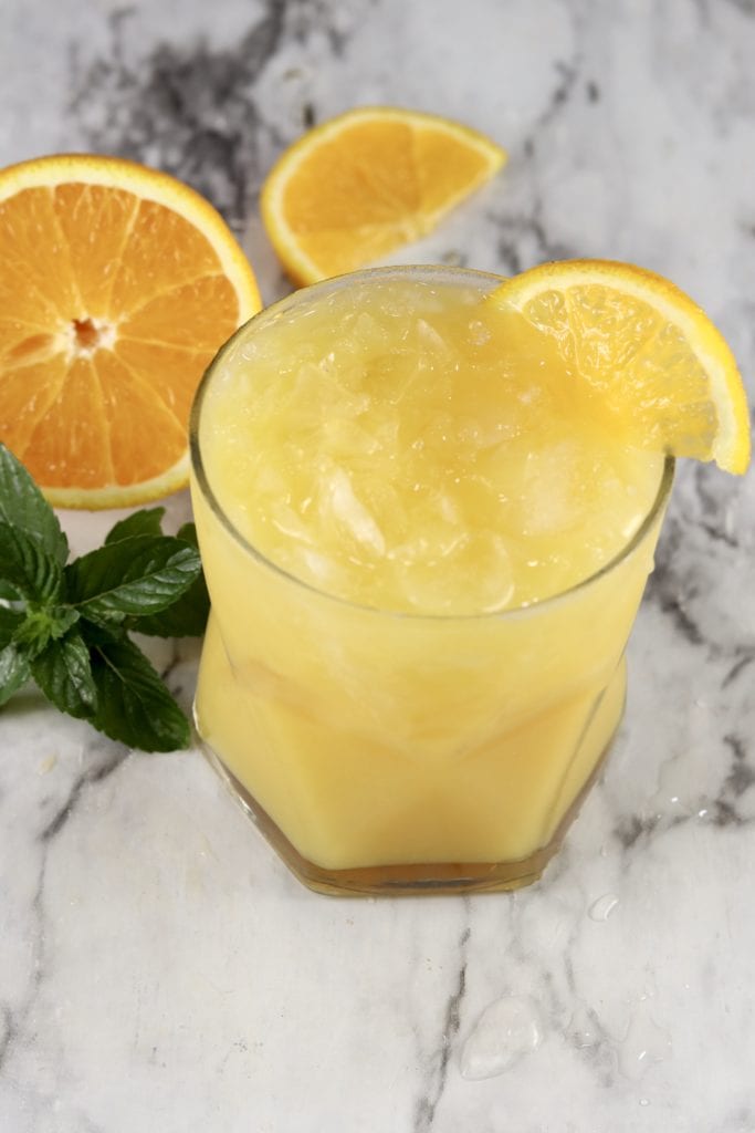 Abbey Cocktail with gin and orange juice, garnished with orange slice