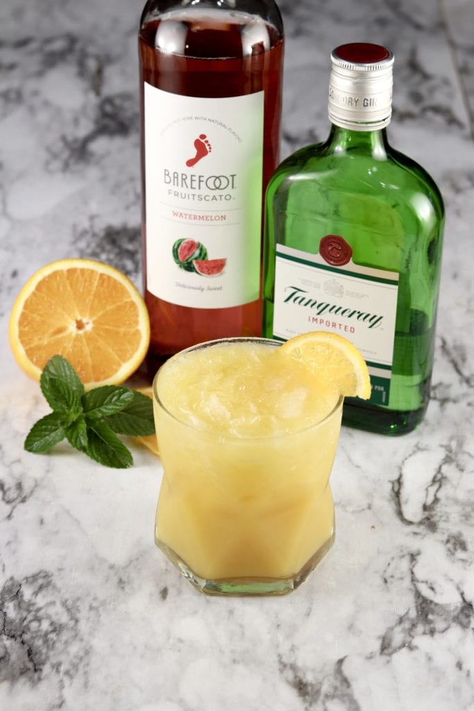 Abbey Cocktail with moscato and gin, with an orange half