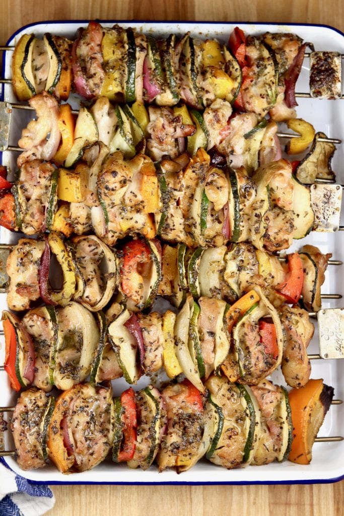 Grilled Chicken and vegetable kebabs on a white enamel tray