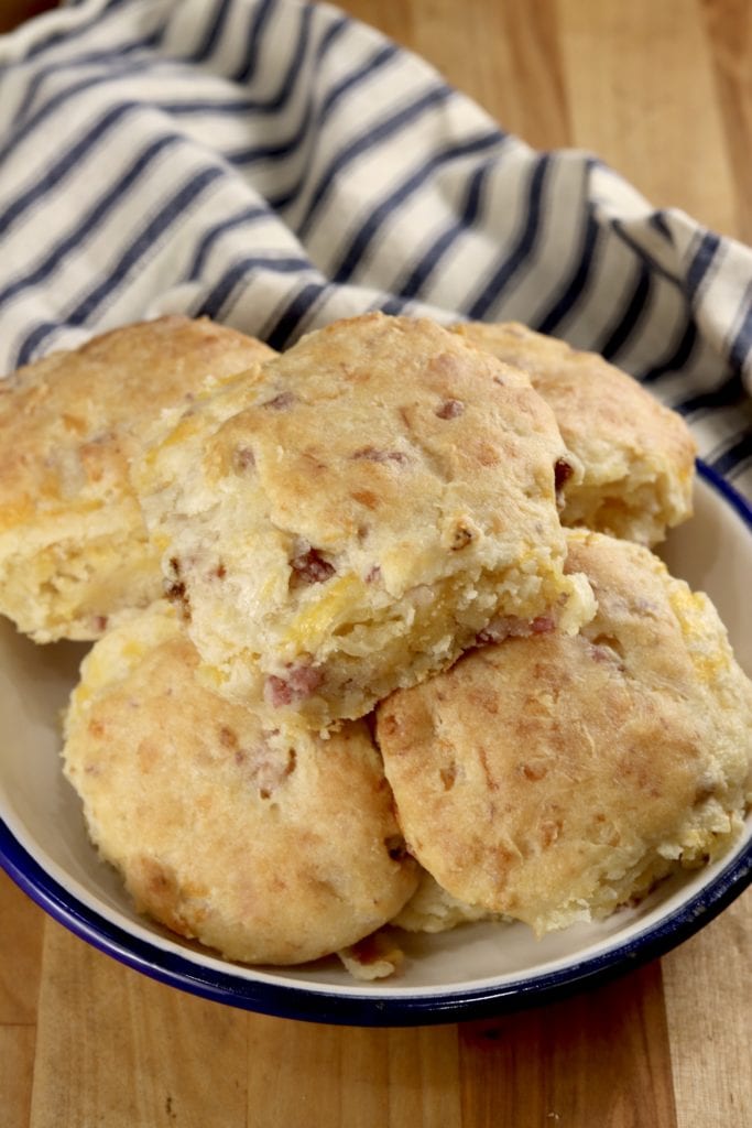Buttermilk Biscuits with Ham and Cheese in a bowl with a striped towel
