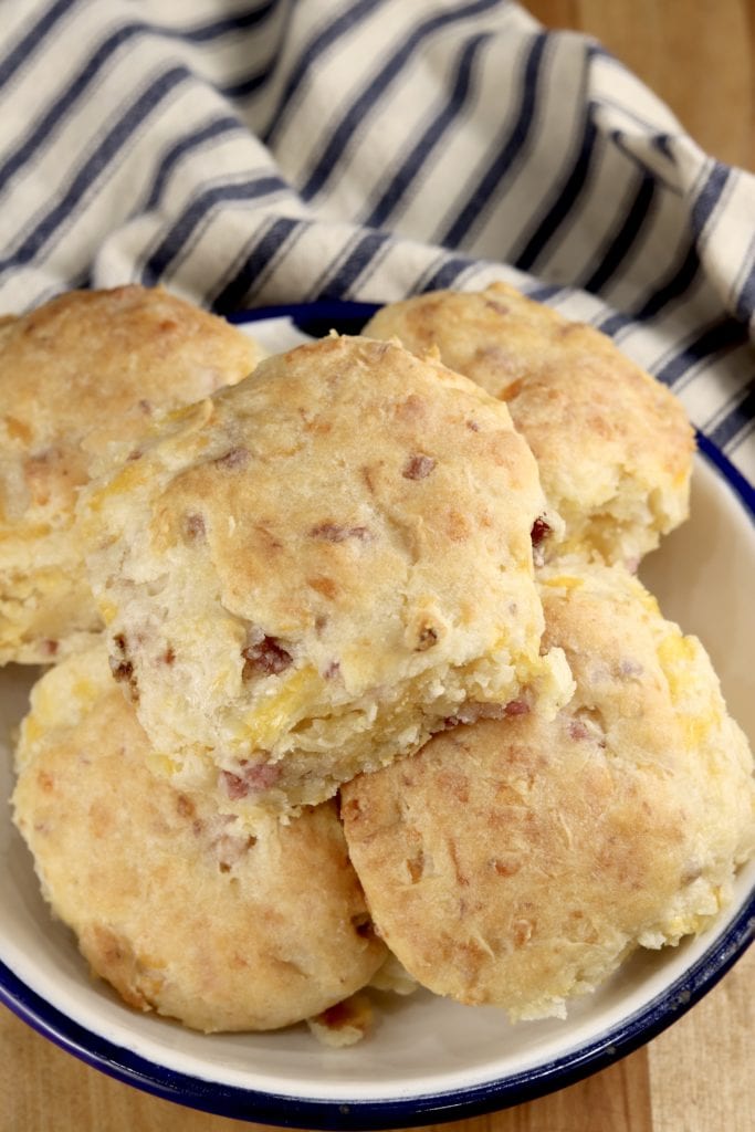 Ham and Cheese Biscuits in a bowl, striped towel in background