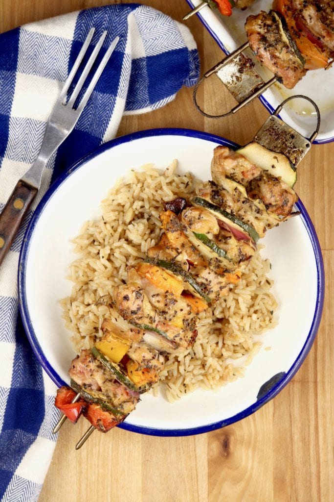 Grilled Chicken Kebabs served over a bowl of rice