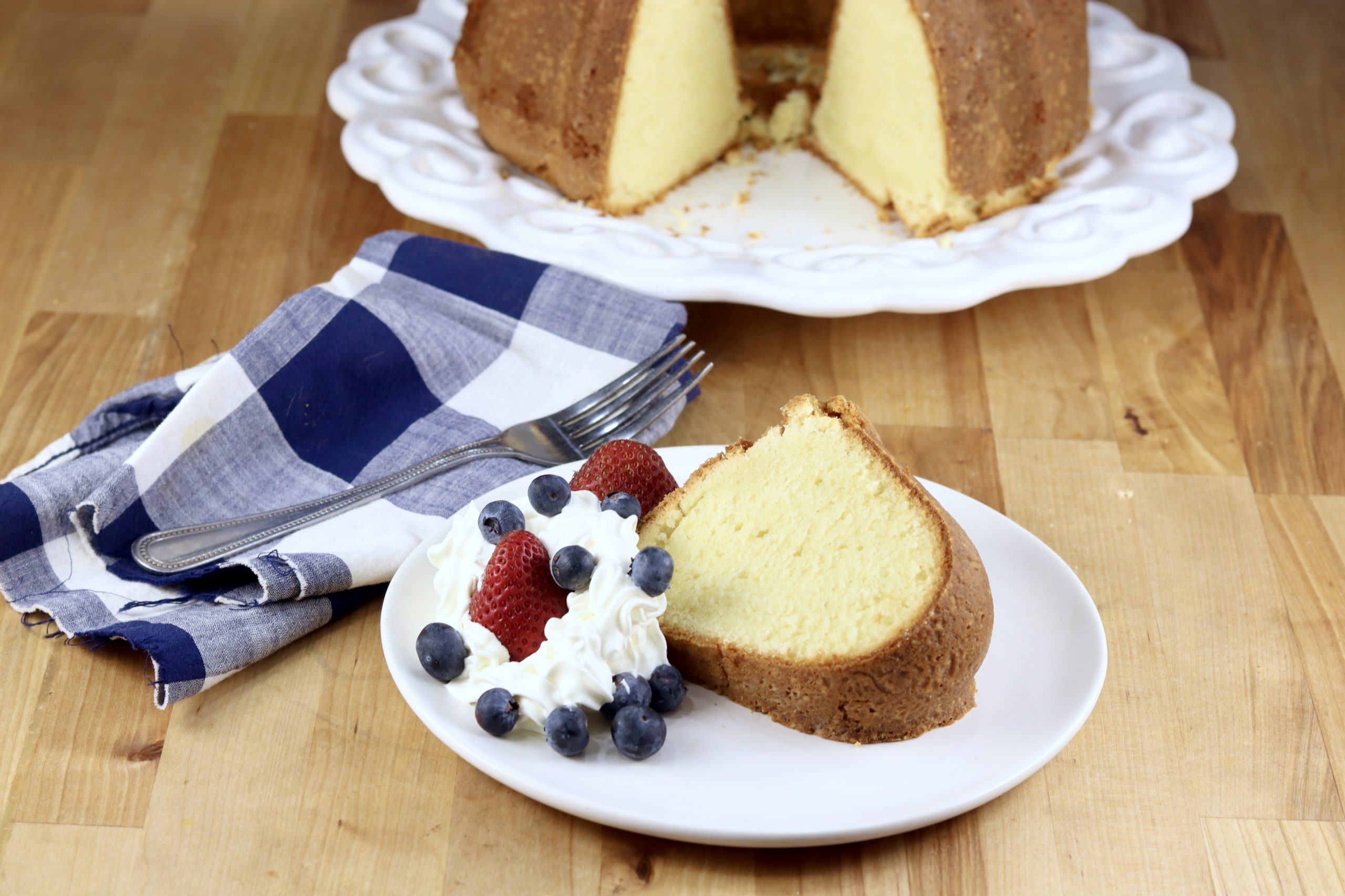 Million Dollar Pound Cake with berries and whipped cream