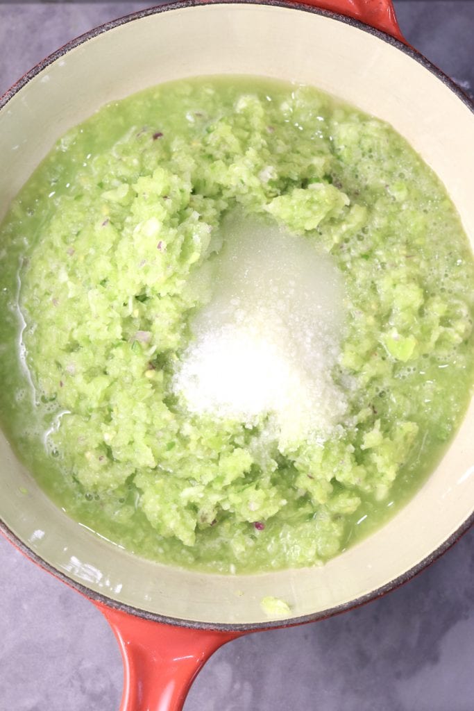 Saucepan with green tomatoes, sugar and salt
