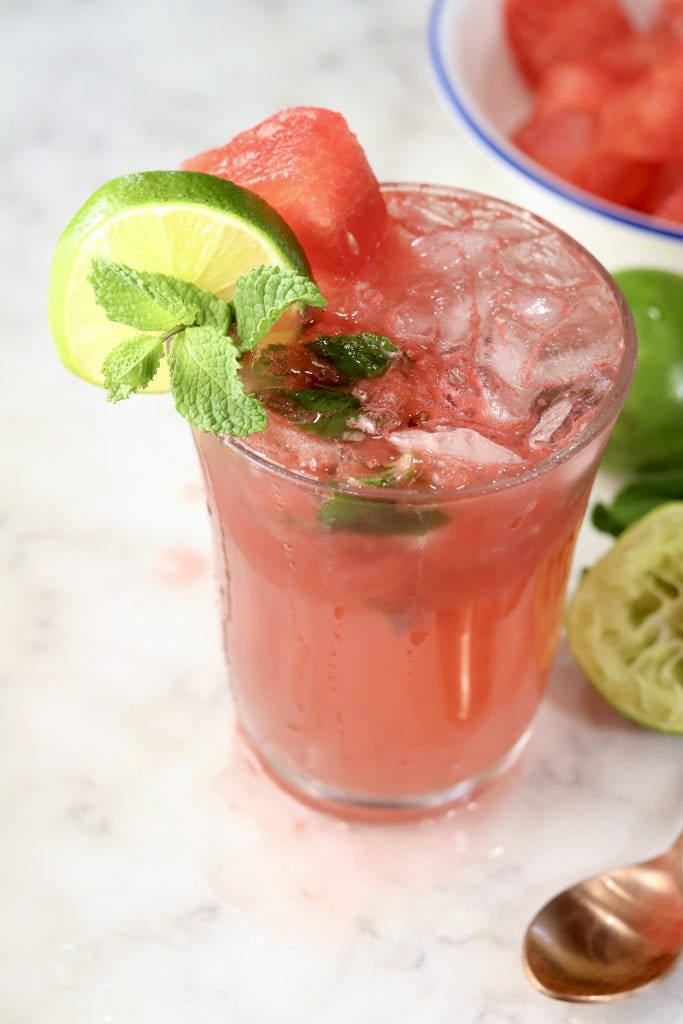 Watermelon Mojitos garnished with lime and mint