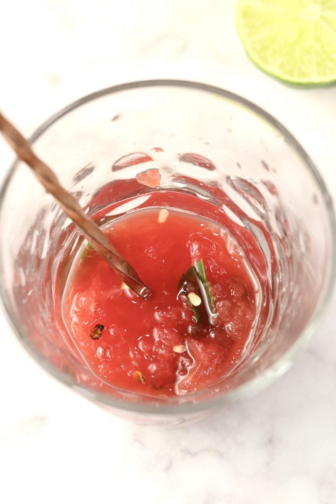 Muddled watermelon and mint for mojitos in a glass