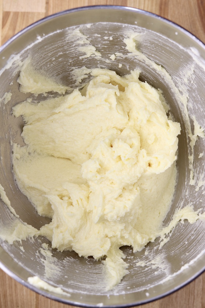 Mixer bowl with creamed butter, sugar, eggs and vanilla for cookies