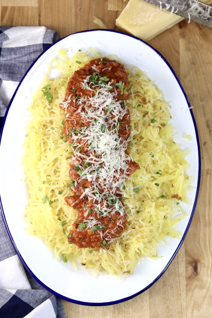 Platter of spaghetti squash, topped with homemade marinara sauce, parmesan and fresh parsley