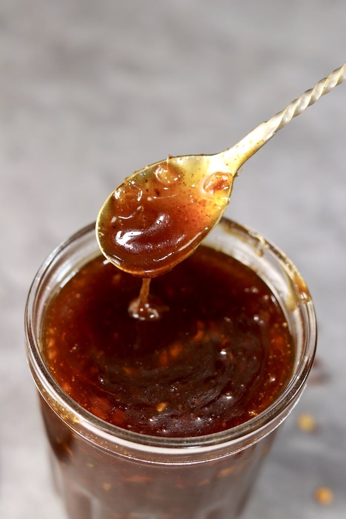 jar with peach bbq sauce, spoon dipping sauce