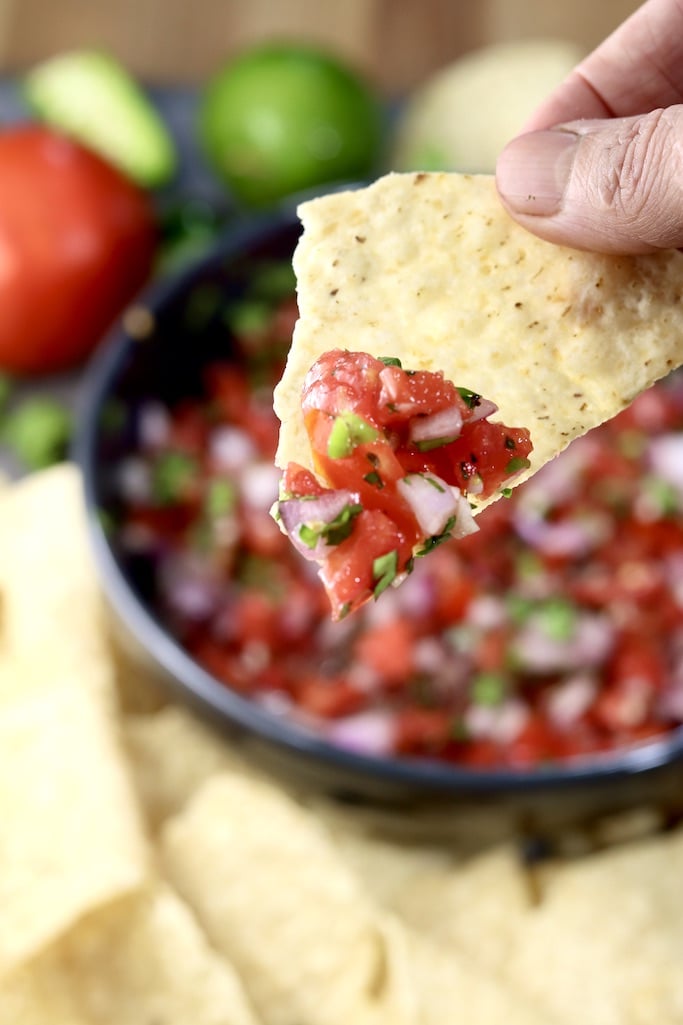 Pico de Gallo served on a tortilla chip, close up view