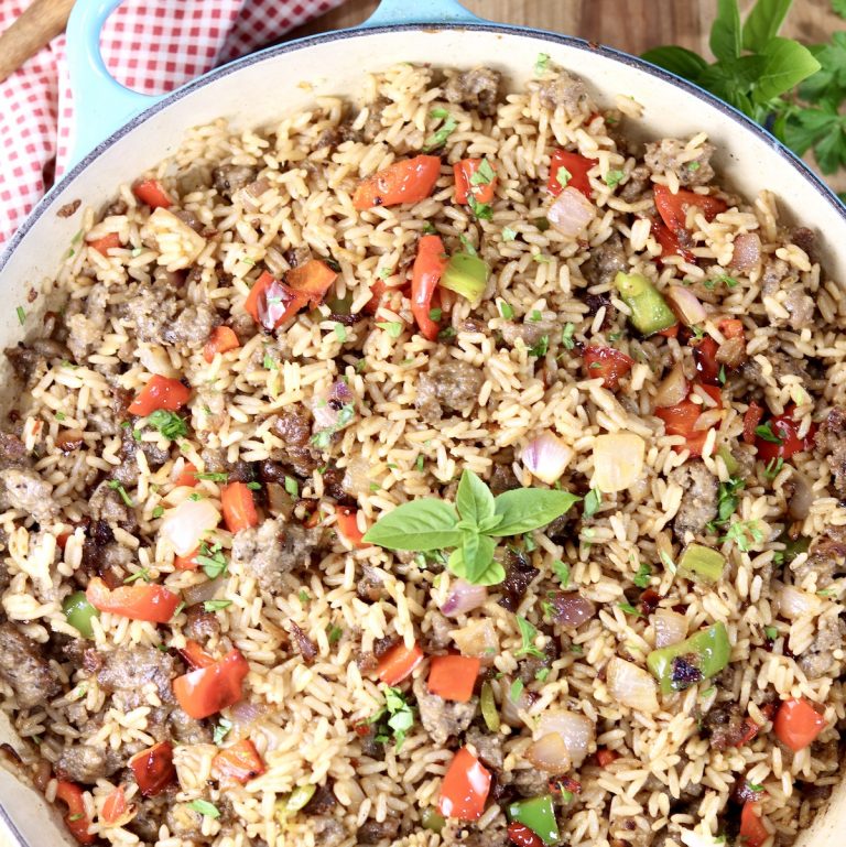 Sausage and Pepper Rice dinner in a large pan, garnished with fresh basil leaves