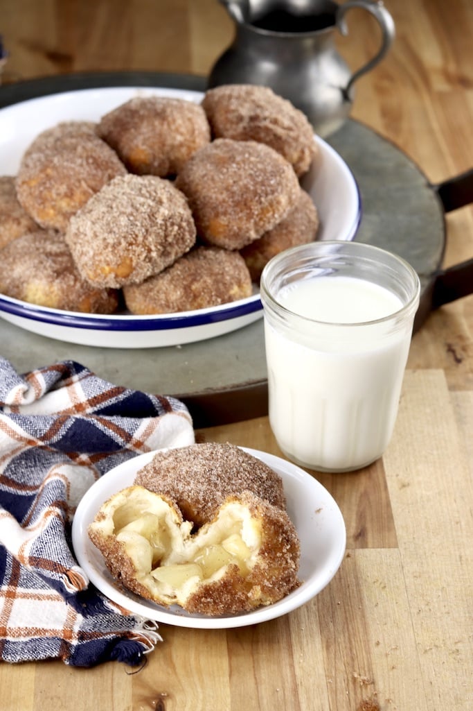 Air Fryer Churro Apple Pie Bombs are a sweet treat that can be made in about 20 minutes with only 5 ingredients. Serve this quick and easy treat for a quick weekend breakfast or top with vanilla ice cream for a decadent dessert. Pie is probably the most requested dessert at our house but it's the one I make the least often. I just hate fooling with pie crust when cookies and cakes are faster and easier. Well that is until I made these apple pie bombs! It is seriously simple and the crust is made with canned biscuit dough. Churro Apple Pie Bombs with milk, one serving and pie plate filled