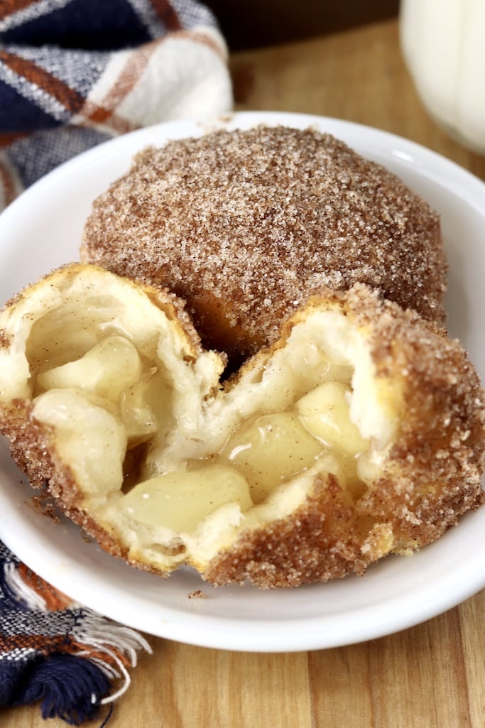 saucer with 2 churro apple pie bombs, one split open 