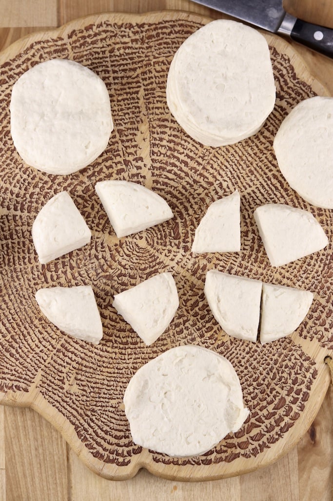 Can biscuits on a board with 2 cut into quarters for making donut holes