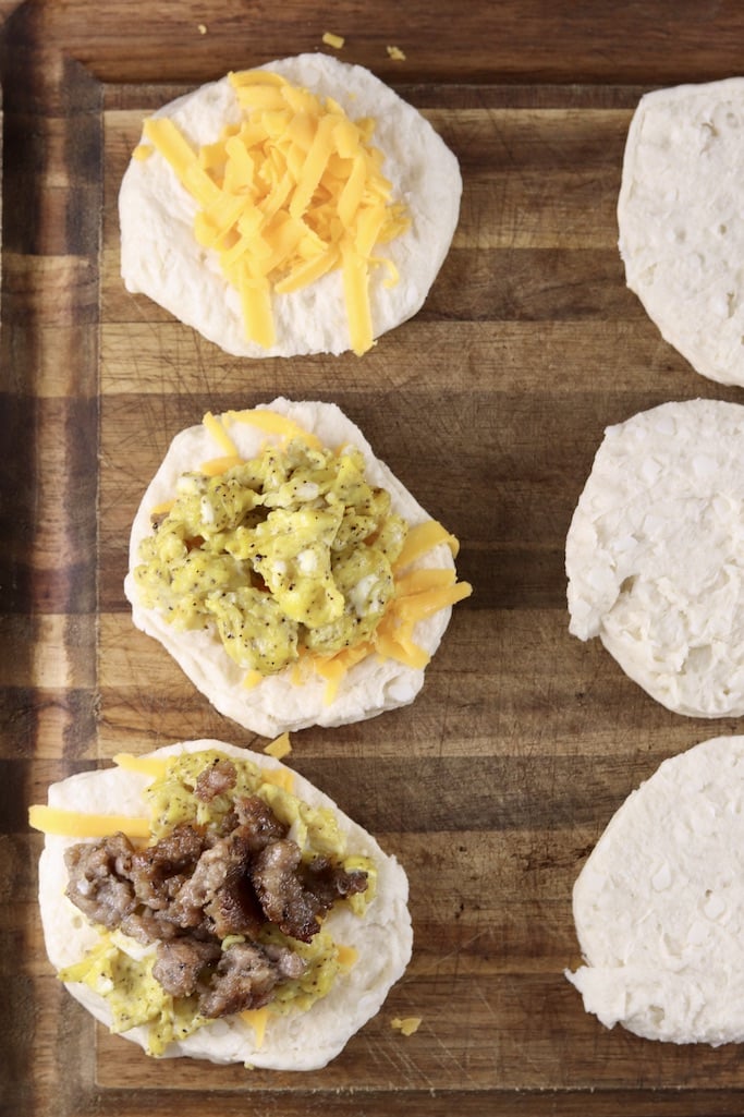 making breakfast biscuits, with cheese, eggs and sausage
