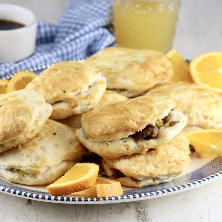 Air Fryer Sausage Biscuits on a platter with orange slices
