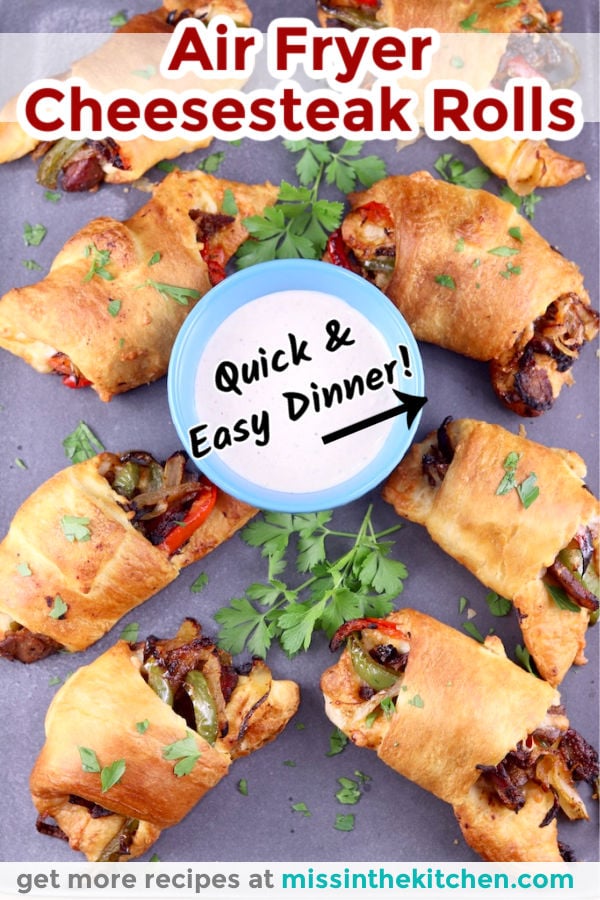 Air Fryer Cheesesteak Rolls with text overlay - on a platter with bowl of horseradish sauce in center