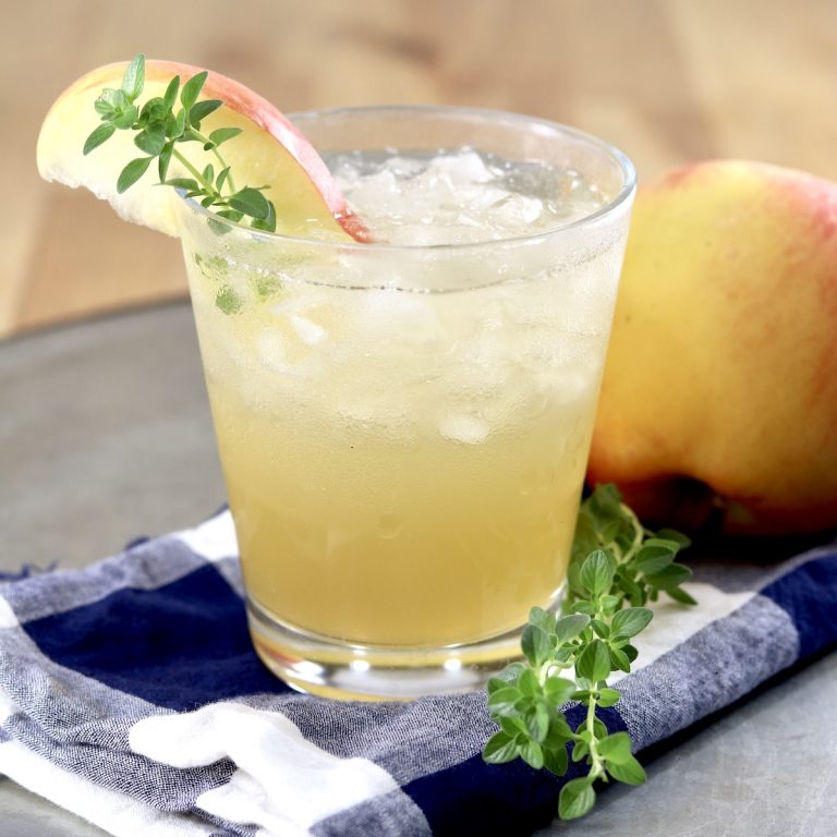 Apple Cider Gin Cocktail -small glass with ice, apple and thyme garnish
