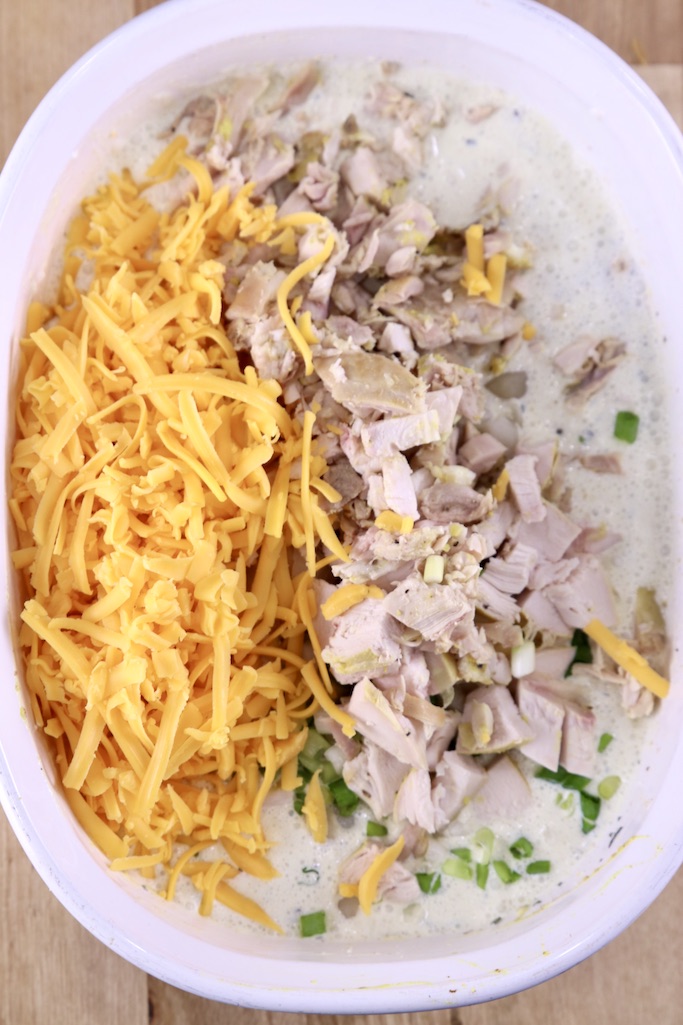 adding chicken and cheese in rice casserole