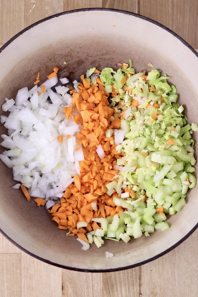 Dutch oven with onions, carrots, celery and garlic
