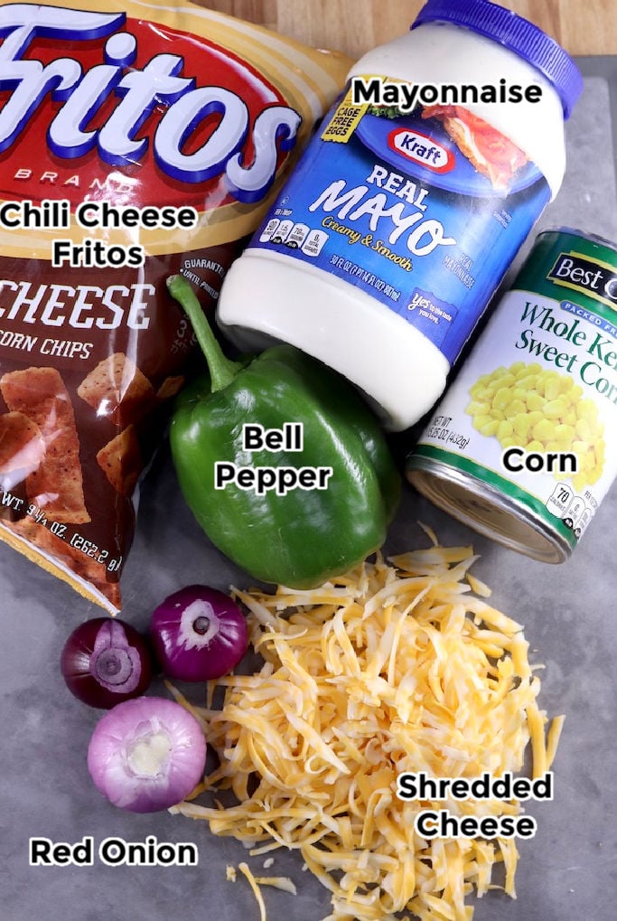 Mayonnaise, cheese, red onion, bell pepper, canned corn and Chili Cheese Fritos for corn salad Ingredients for Frito Corn Salad
